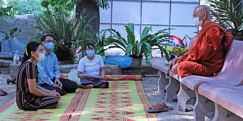 Family Sitting with Monk