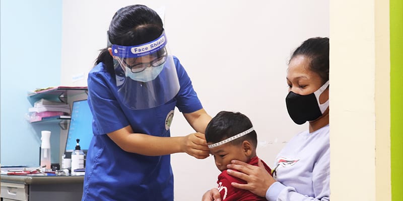 Neurologist Measuring Kid Head