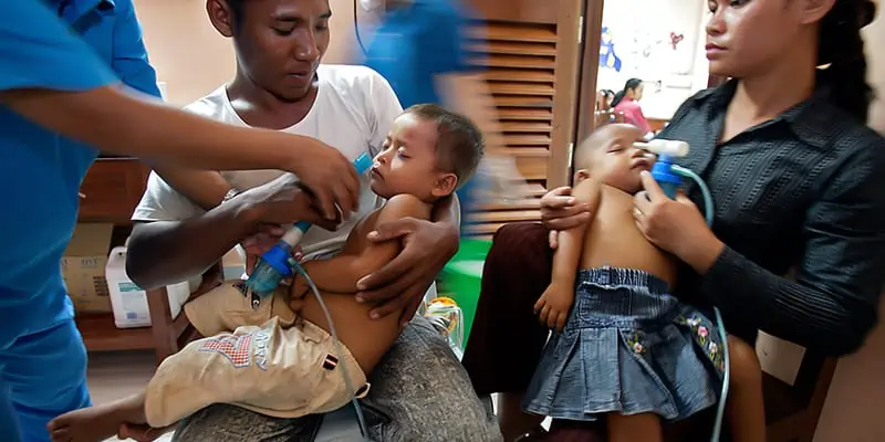 Nurse Showing Parents To Use Medical Devices