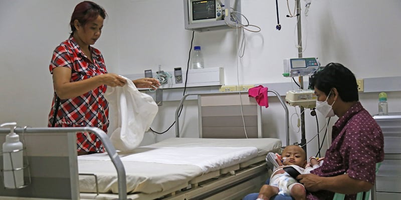 Parents with Child Waiting in Hospital Room