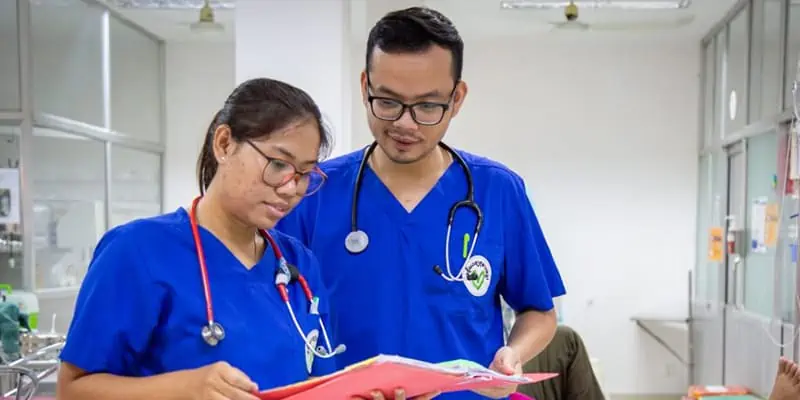Two Asian Doctors Reviewing Document